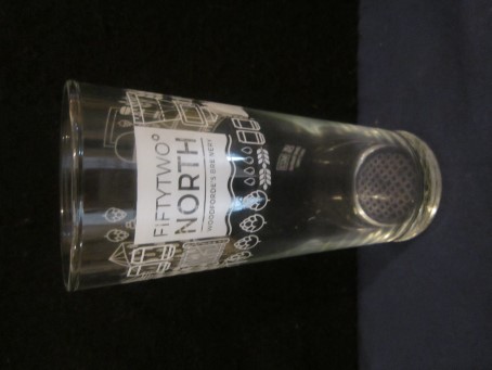 beer glass from the Woodforde's  brewery in England with the inscription 'Fiftytwo North, Woodforde's Brewery'